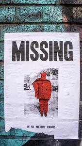 A poster with a red man on the wall